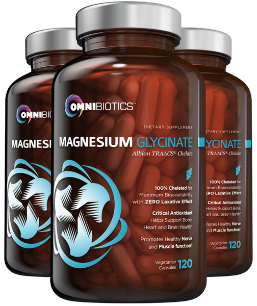 Two bottles of OmniBiotics Magnesium Glycinate supplement, each bottle has a label showing the product name and dosage information. The capsules inside are magnesium glycinate.