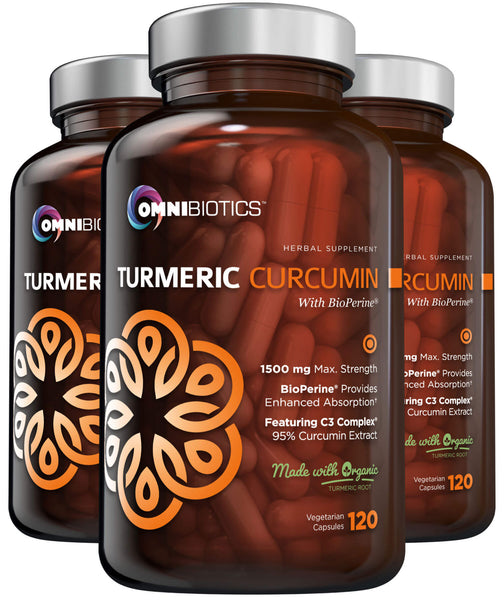 Three bottles of OmniBiotics Turmeric Curcumin supplements, each with a label showing the product name and dosage information. The bottles are labeled as vegan and non-GMO.