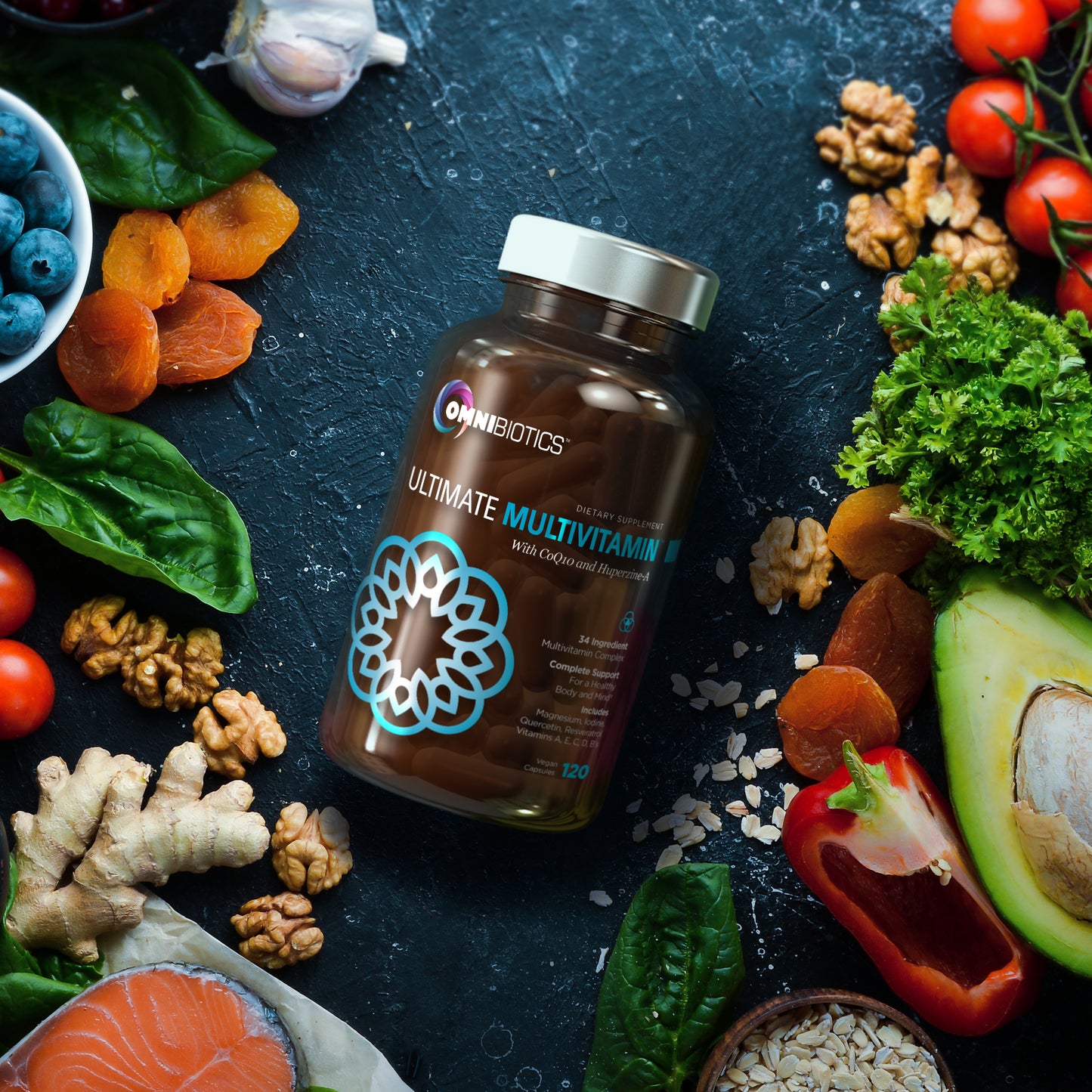 OmniBiotics Ultimate Multivitamin bottle on a dark surface surrounded by nutrient-dense foods—avocado, salmon, spinach, nuts, ginger, dried apricots, tomatoes, peppers, oats, and greens.
